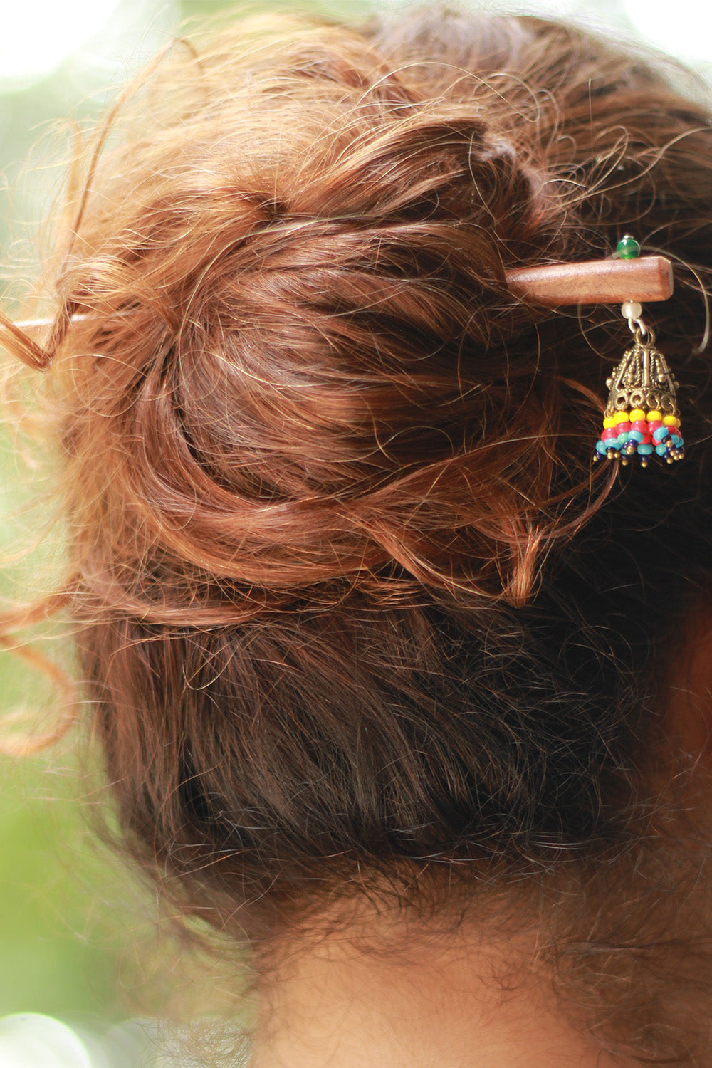 Close-up of a colorful hair clip in a person's hair with a blurred background