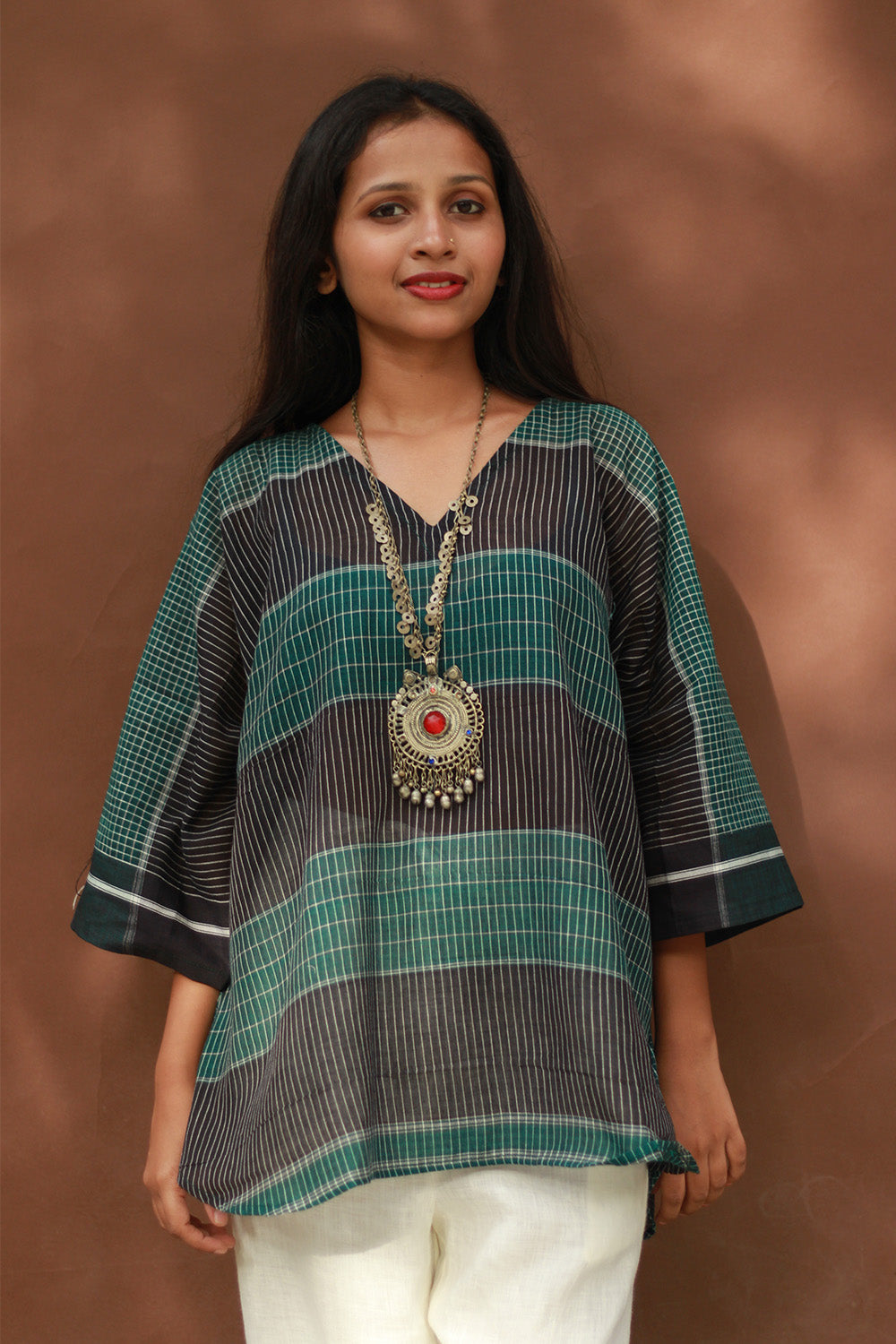 Woman wearing a striped shirt with a brown background