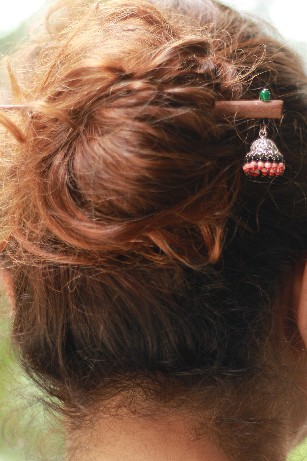 Close-up of a hairpin with decorative elements in a person's hair
