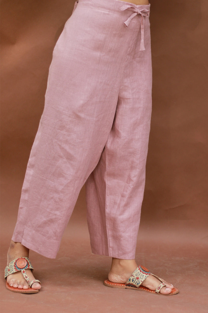 Pink pants worn by a person on a brown background