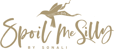 Spoil Me Silly Logo: Ochre Handwritten text with a Hummingbird wearing a Scarf above it.
